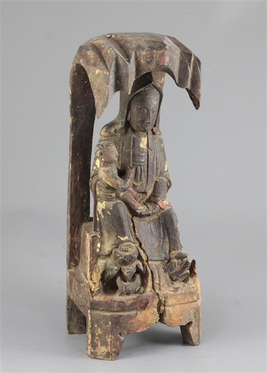 A Chinese lacquered wood group of Guanyin and a child, 17th century, 34.5cm, losses and splits